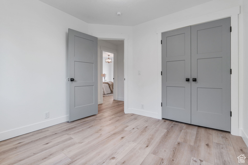 Unfurnished bedroom featuring light hardwood / wood-style flooring and a closet