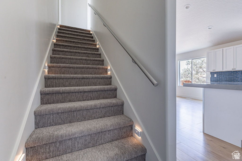 Stairs featuring hardwood / wood-style floors