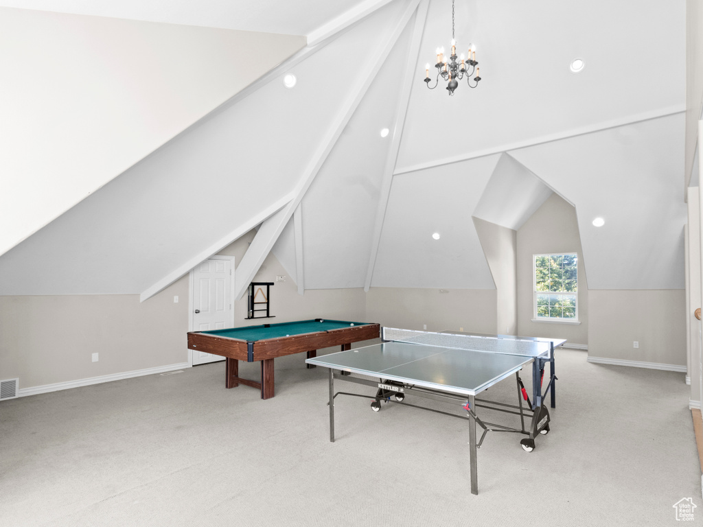 Game room with billiards, light colored carpet, lofted ceiling, and a chandelier