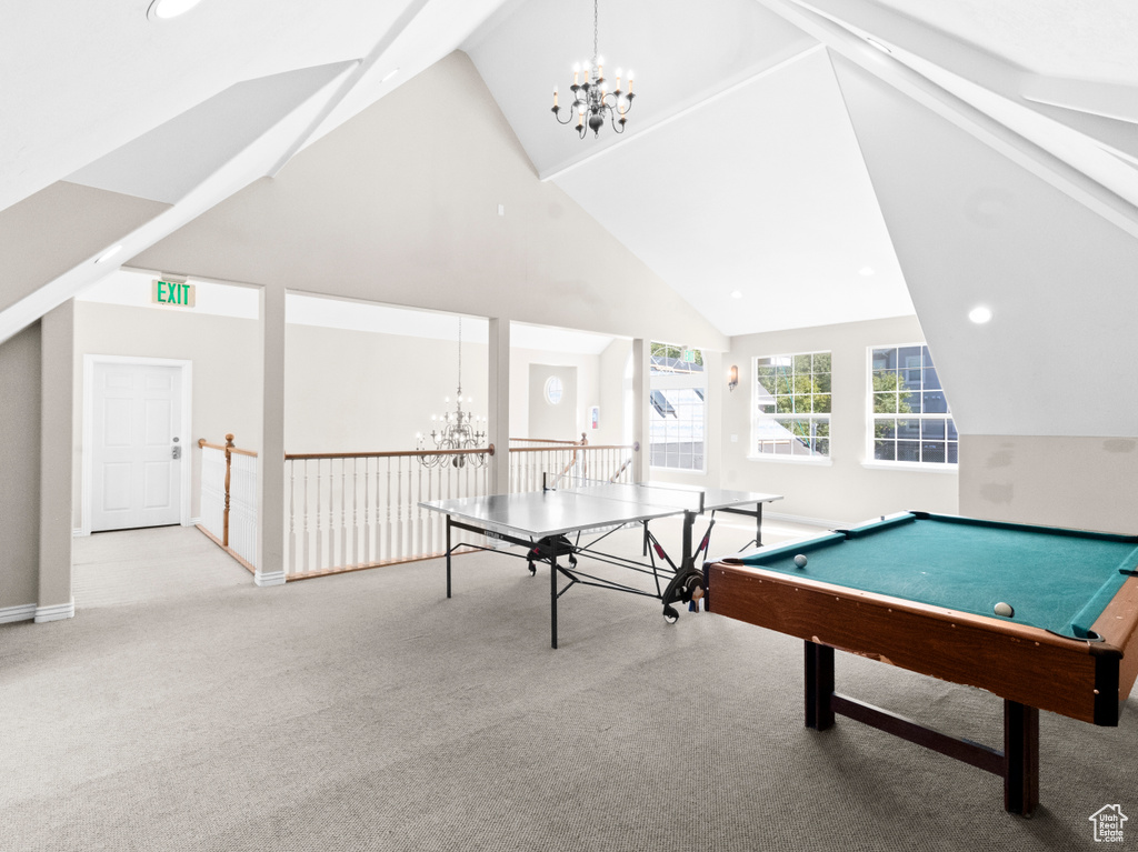 Game room featuring an inviting chandelier, carpet, pool table, and high vaulted ceiling