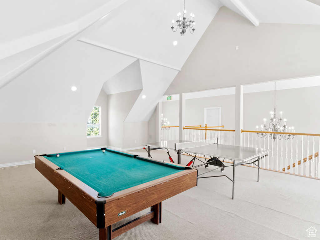 Rec room featuring vaulted ceiling, an inviting chandelier, and light carpet