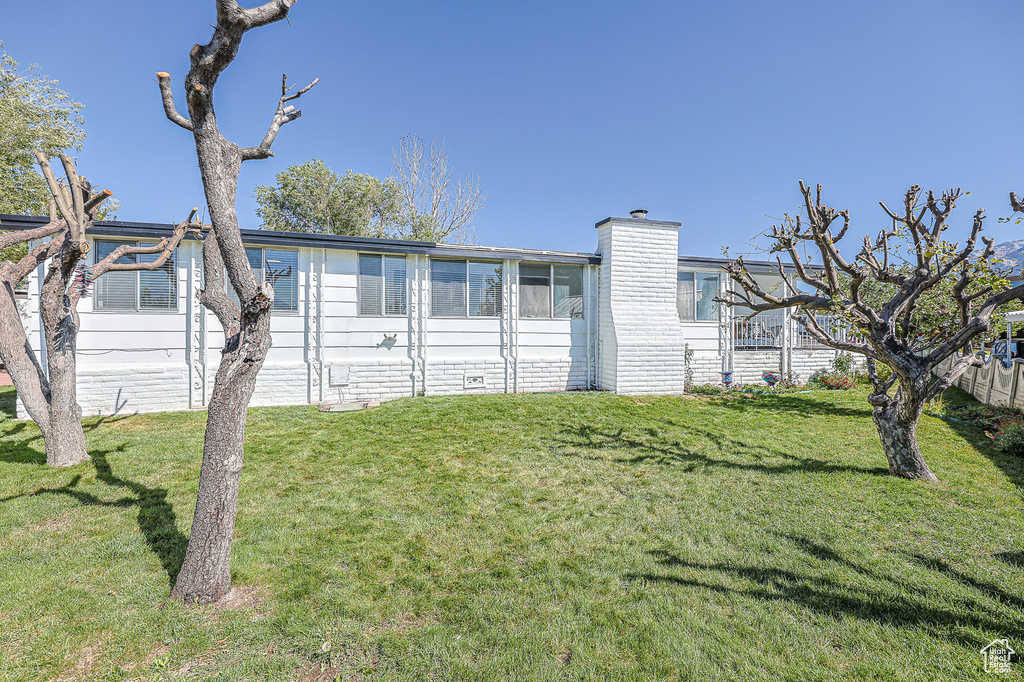 View of property exterior with a yard