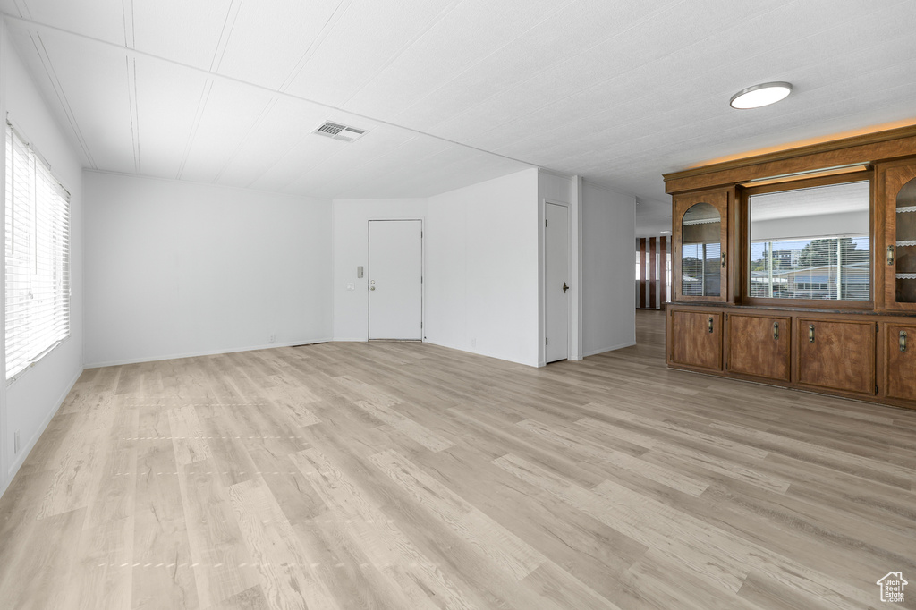 Unfurnished living room featuring light hardwood / wood-style floors