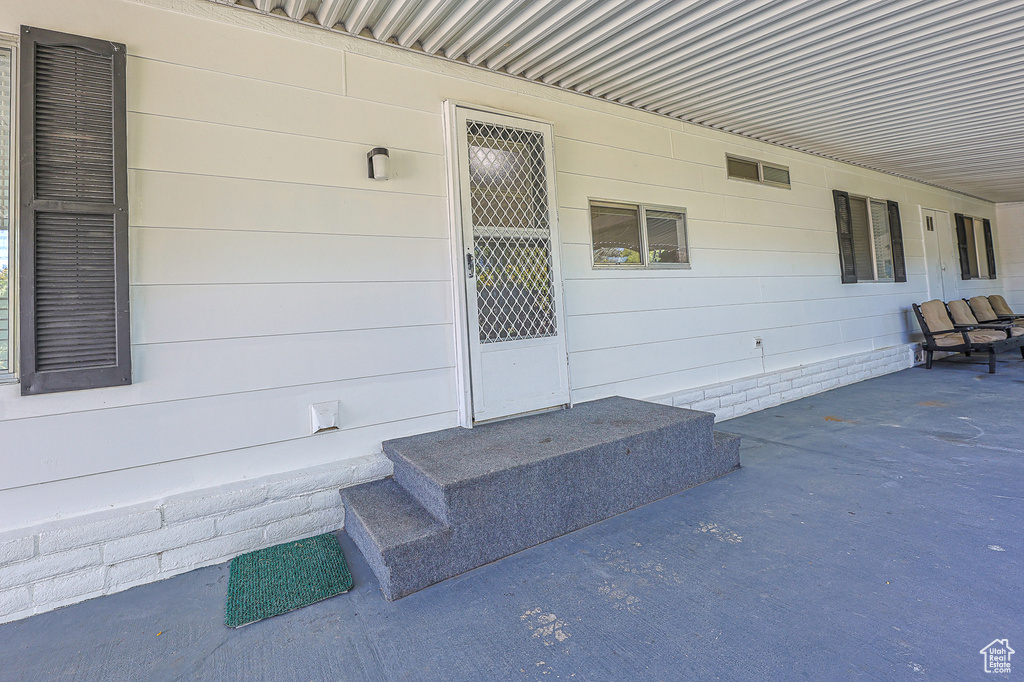 Property entrance with a patio area