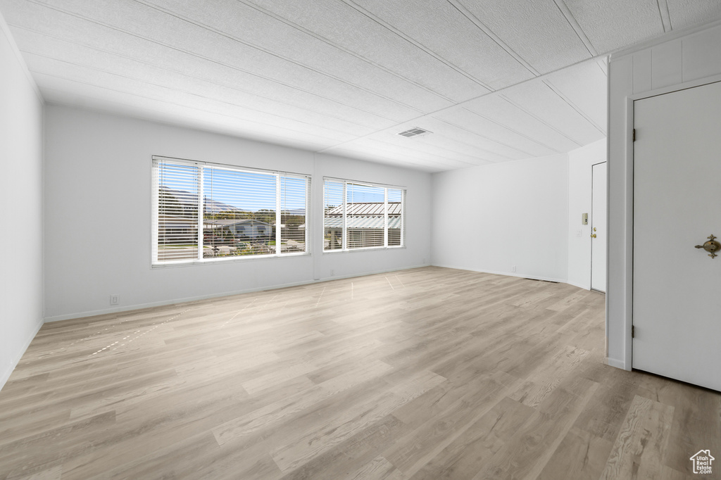 Unfurnished room with light wood-type flooring