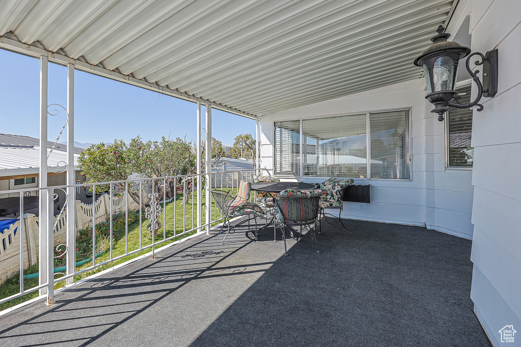 Unfurnished sunroom with lofted ceiling and plenty of natural light