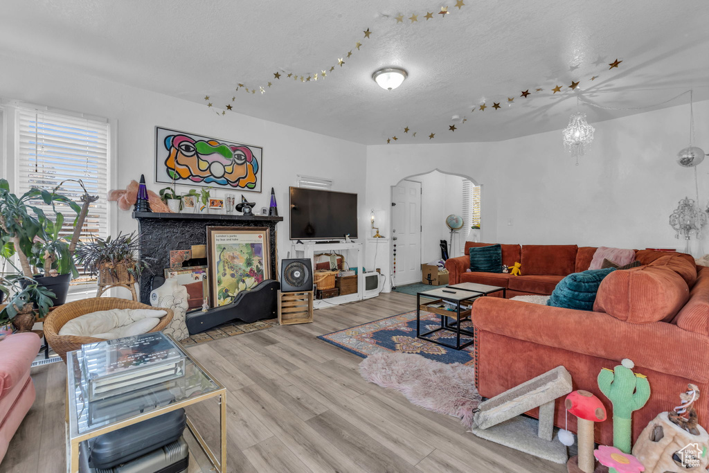 Living room featuring an inviting chandelier and light wood-type flooring