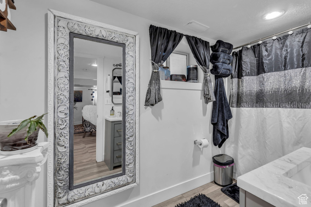 Bathroom with vanity and hardwood / wood-style floors