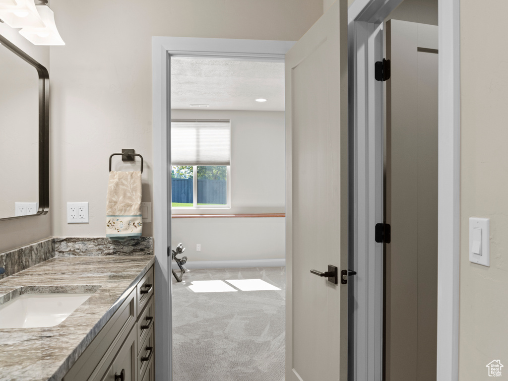 Bathroom featuring a textured ceiling and vanity