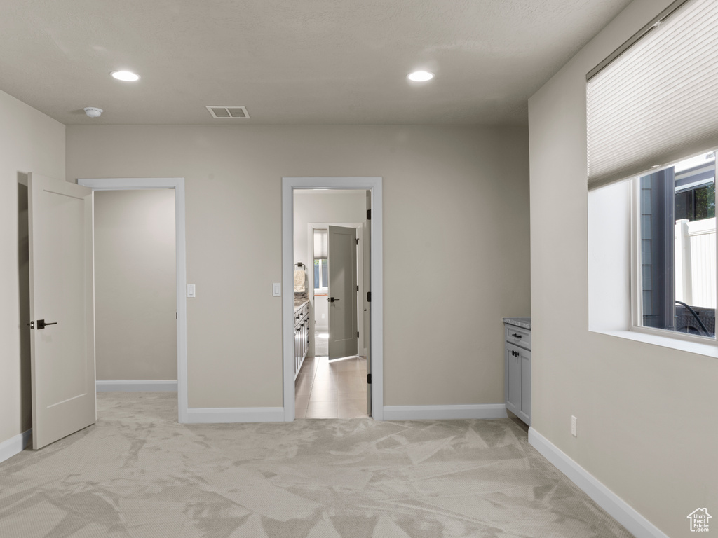 Hallway with light colored carpet