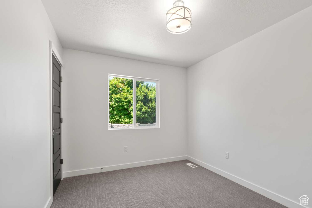 Spare room with a textured ceiling and carpet floors