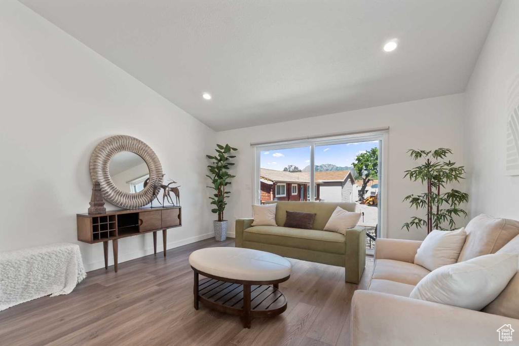 Living room featuring wood-type flooring and lofted ceiling