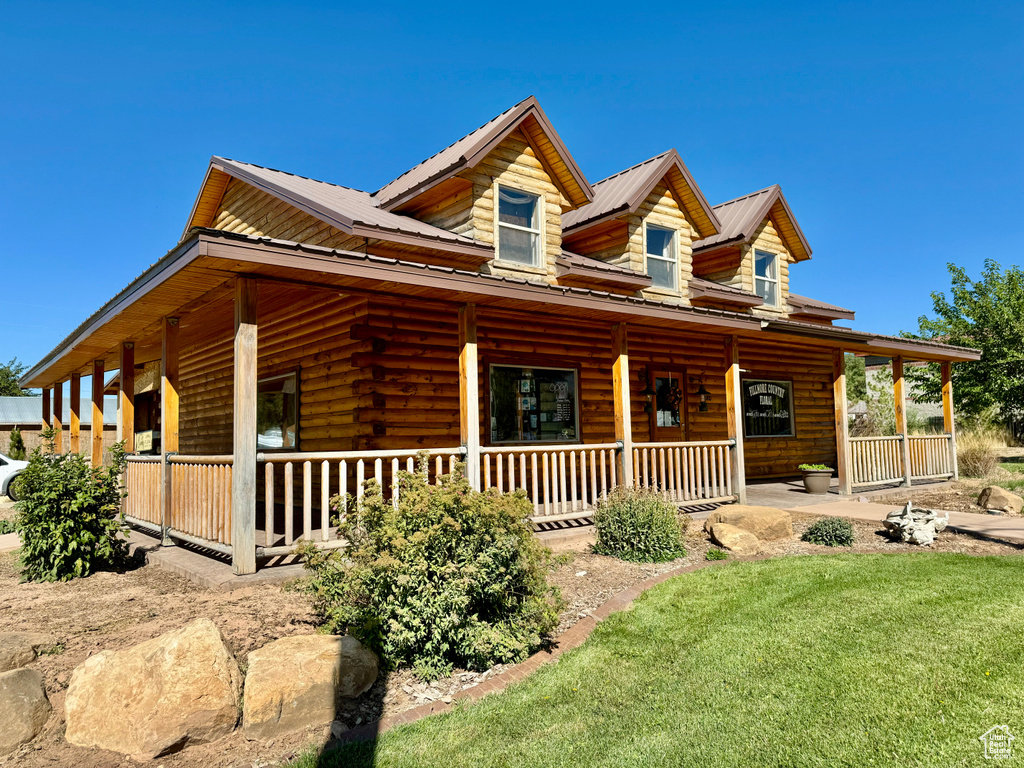 Cabin with a front yard and a porch