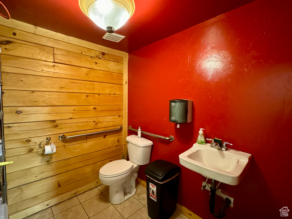 Bathroom with toilet and tile patterned floors