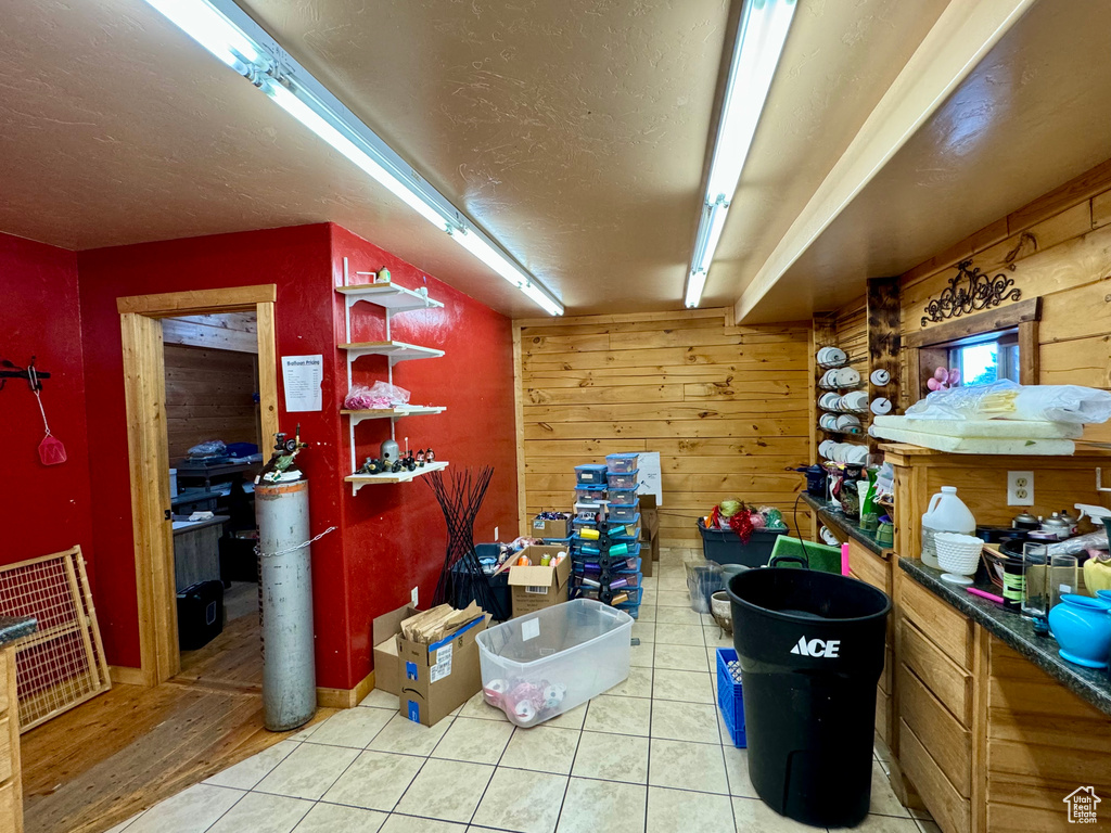 Interior space with hardwood / wood-style flooring, wooden walls, and a textured ceiling