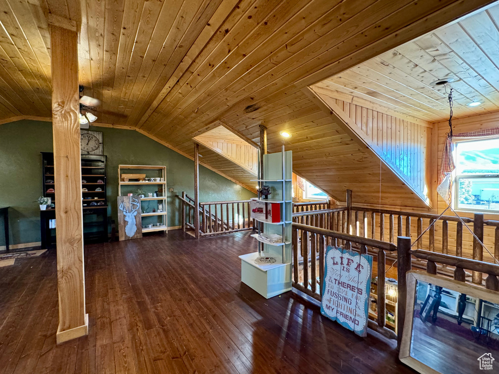 Interior space featuring wooden ceiling, lofted ceiling, and dark wood-type flooring