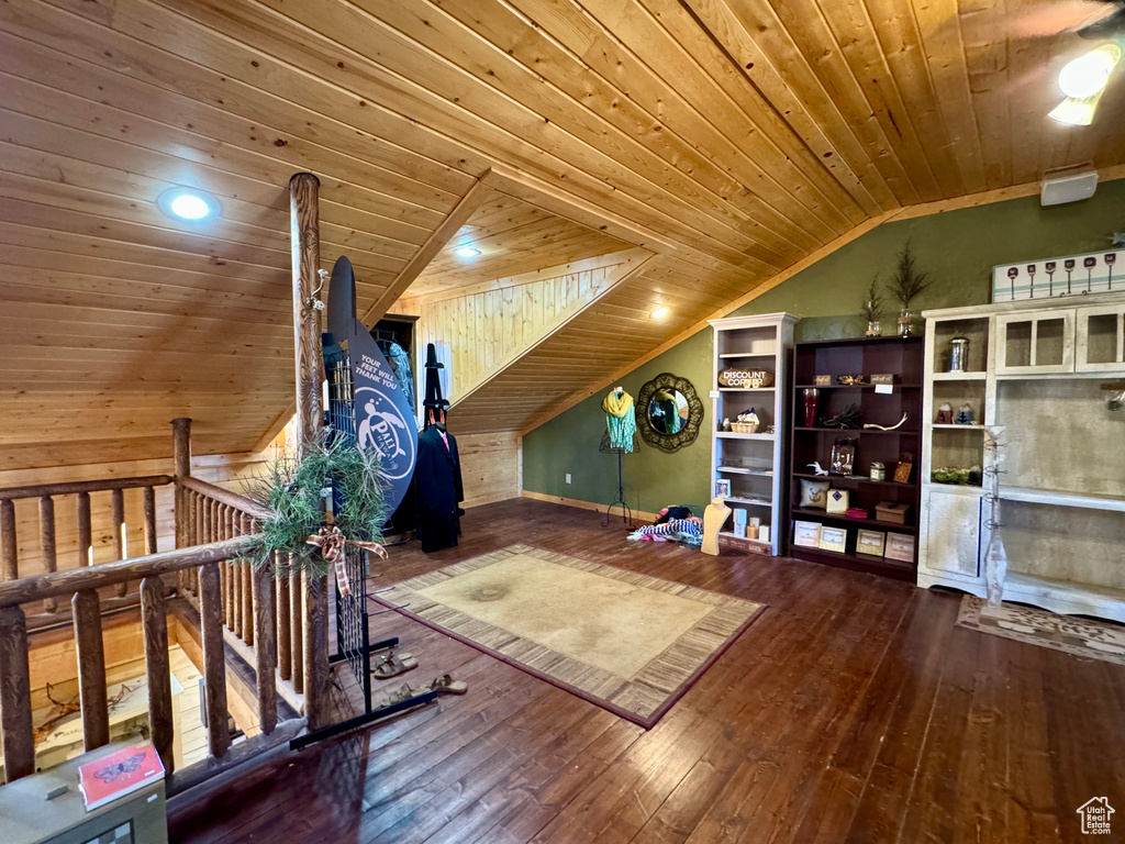 Workout room with wood-type flooring, wood ceiling, and lofted ceiling