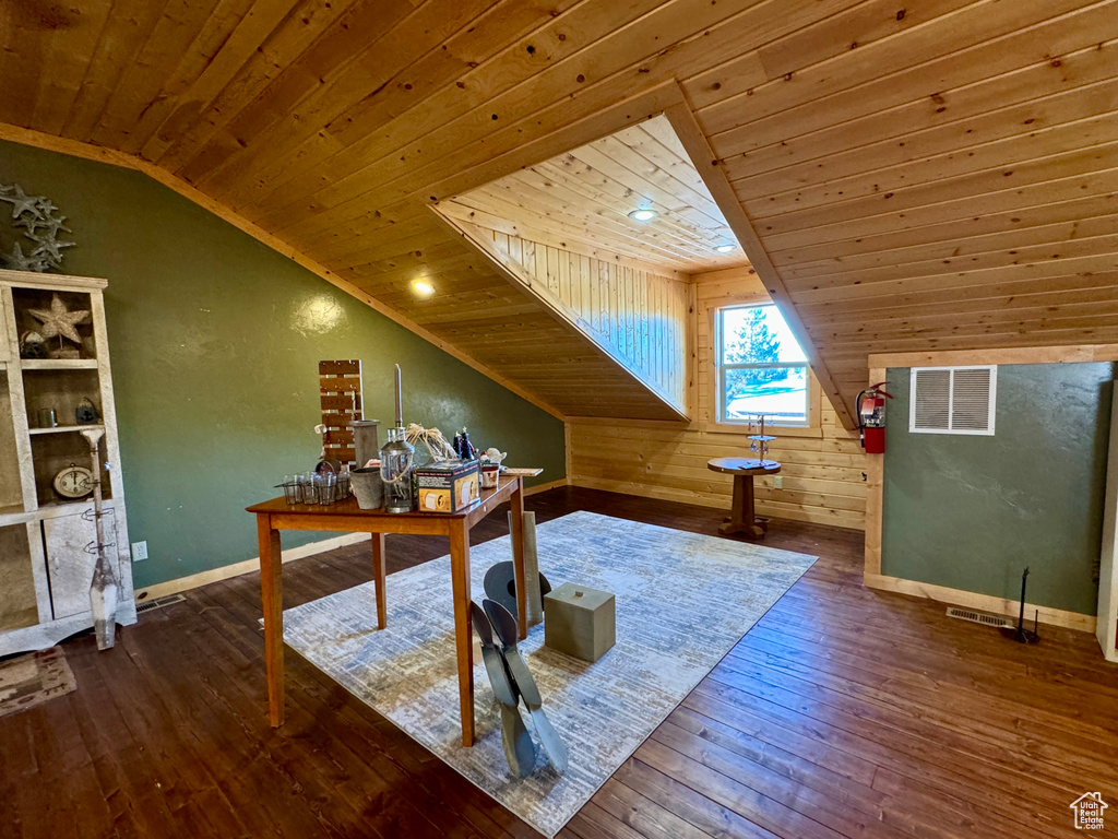 Home office with wood-type flooring, wood ceiling, wood walls, and vaulted ceiling