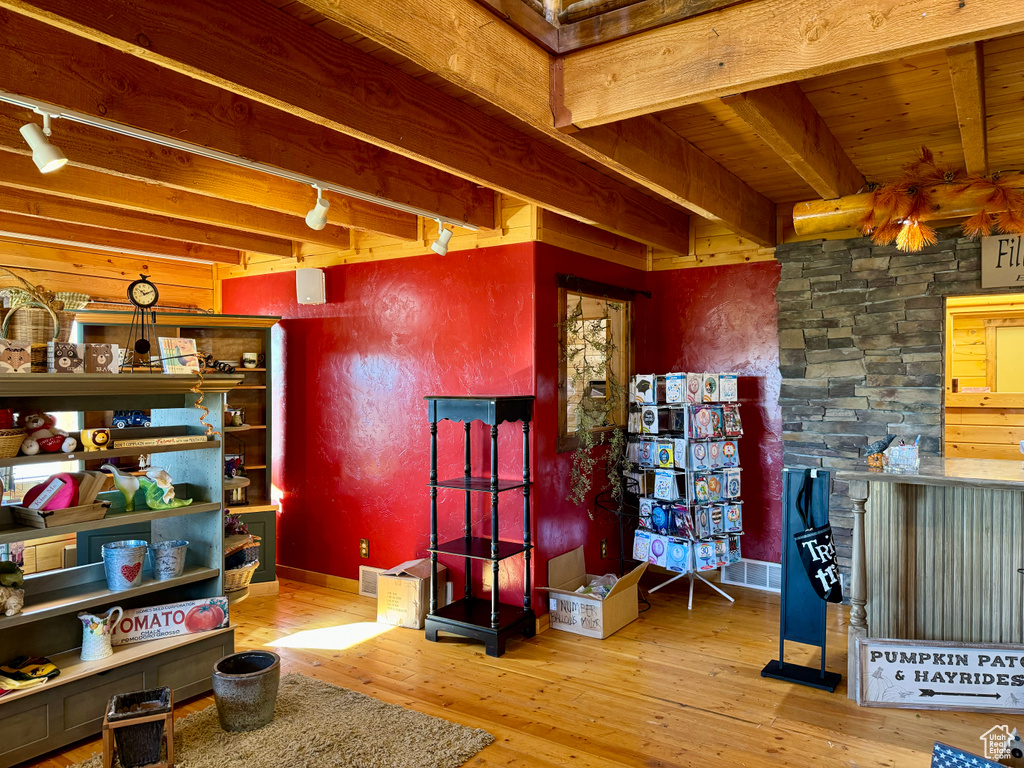 Miscellaneous room featuring beamed ceiling, hardwood / wood-style flooring, and rail lighting