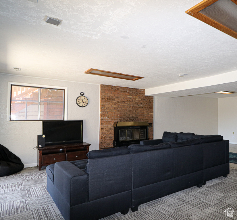 Living room with a textured ceiling and light colored carpet