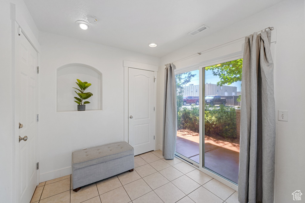 Entryway with light tile patterned floors