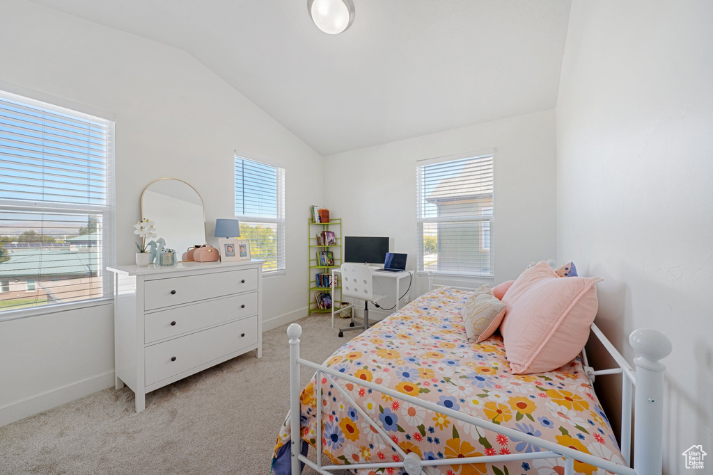 Carpeted bedroom featuring vaulted ceiling