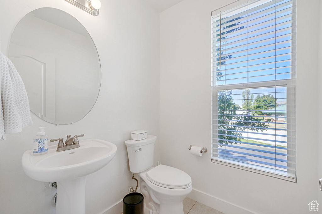 Bathroom with toilet and tile patterned floors