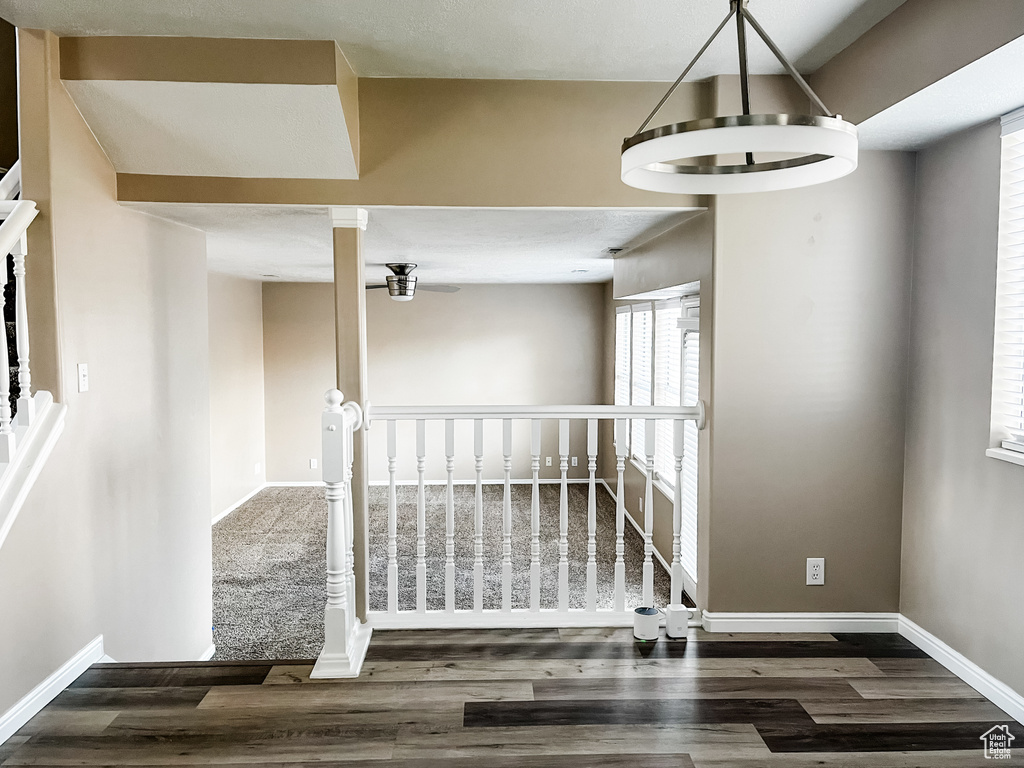 Stairway featuring a notable chandelier and hardwood / wood-style floors