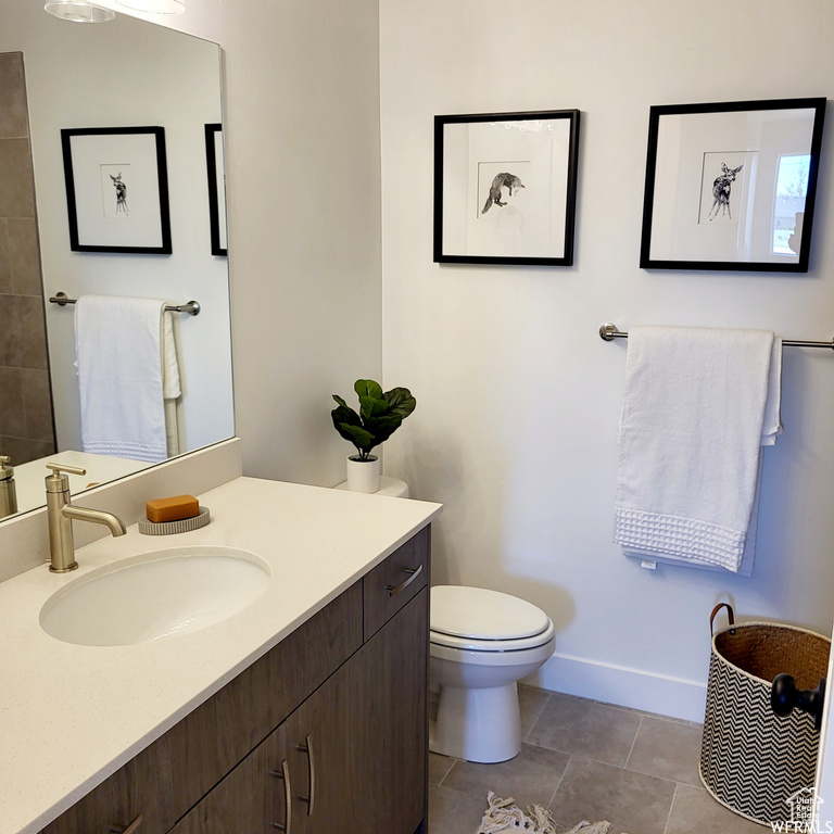 Bathroom with vanity, tile patterned flooring, and toilet