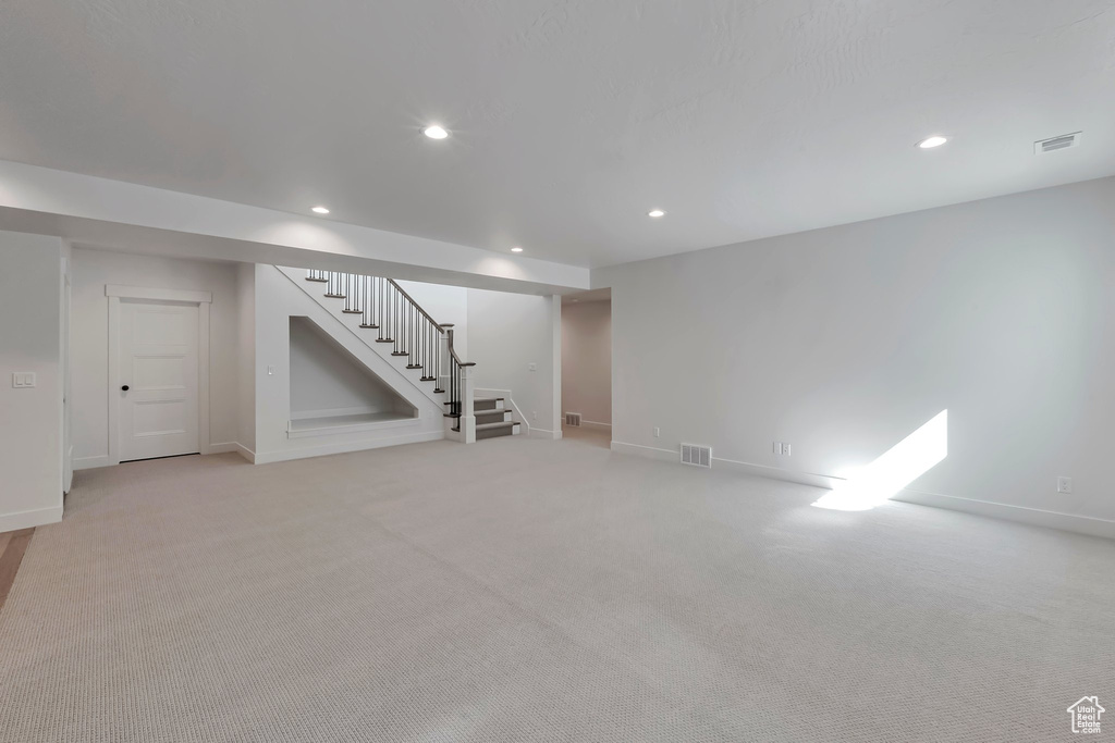 Basement with light colored carpet