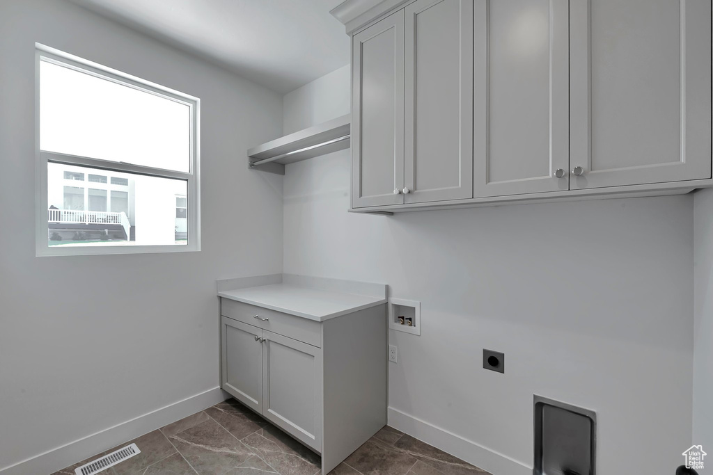 Laundry room with washer hookup, cabinets, plenty of natural light, and hookup for an electric dryer