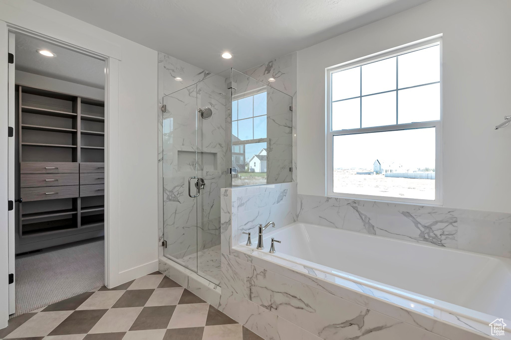 Bathroom featuring a healthy amount of sunlight and shower with separate bathtub