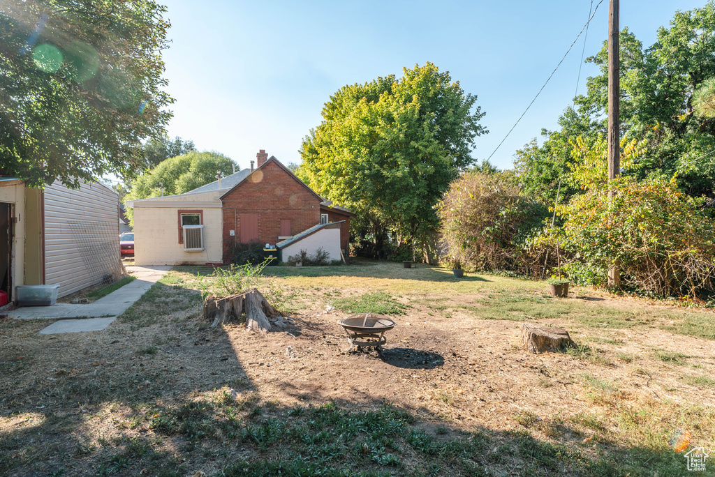 View of yard featuring an outdoor fire pit