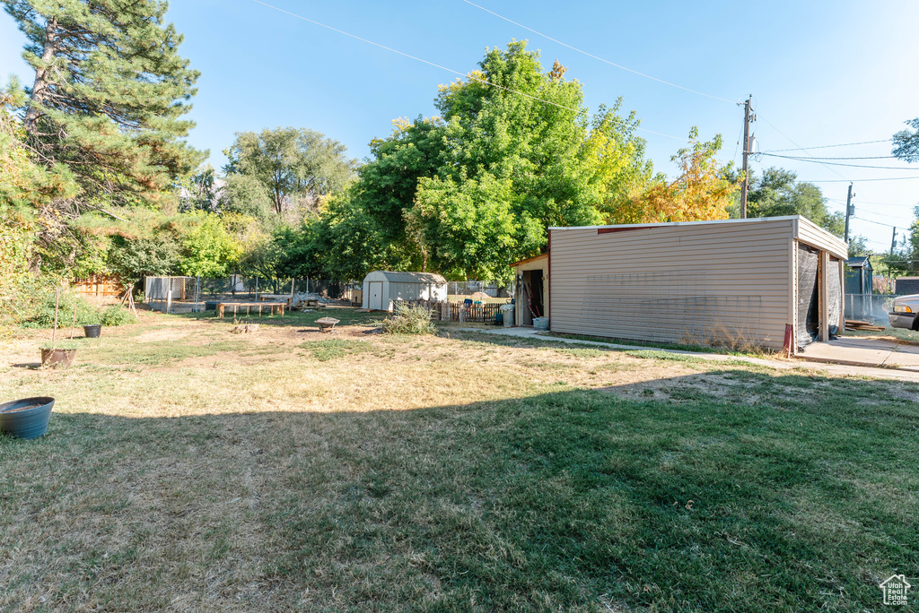 View of yard with a storage unit