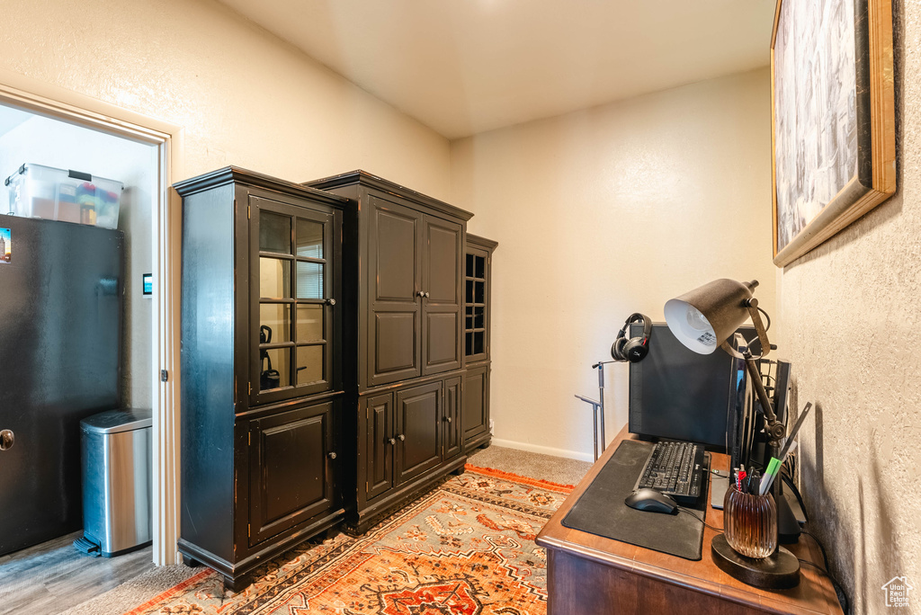 Office with hardwood / wood-style flooring