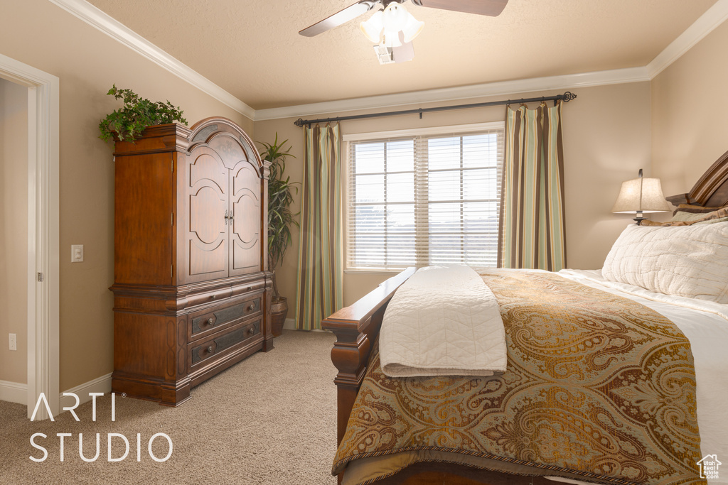 Bedroom with carpet flooring, ornamental molding, and ceiling fan