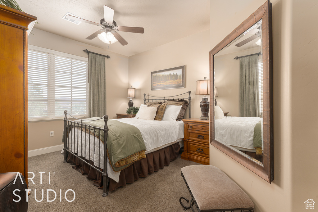 Bedroom featuring ceiling fan and light carpet