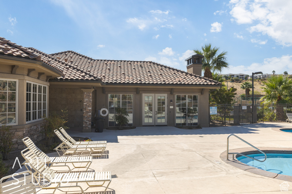 View of swimming pool featuring french doors and a patio area