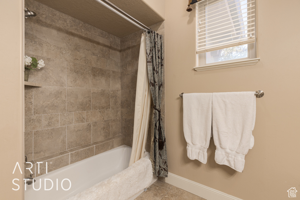 Bathroom with shower / tub combo and tile patterned floors