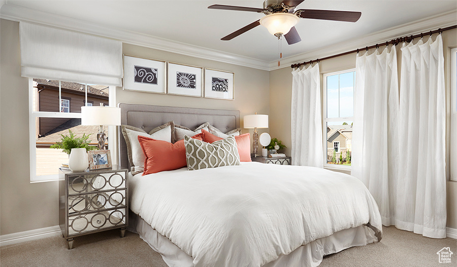 Bedroom with carpet flooring, ornamental molding, multiple windows, and ceiling fan