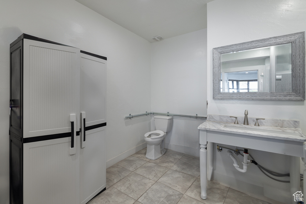 Bathroom with sink, tile patterned flooring, and toilet