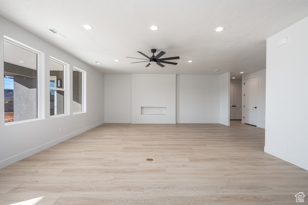 Spare room featuring ceiling fan and light hardwood / wood-style flooring