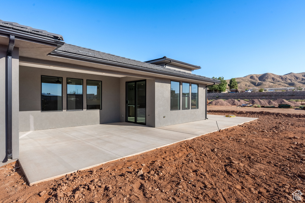 Rear view of property featuring a patio and a mountain view