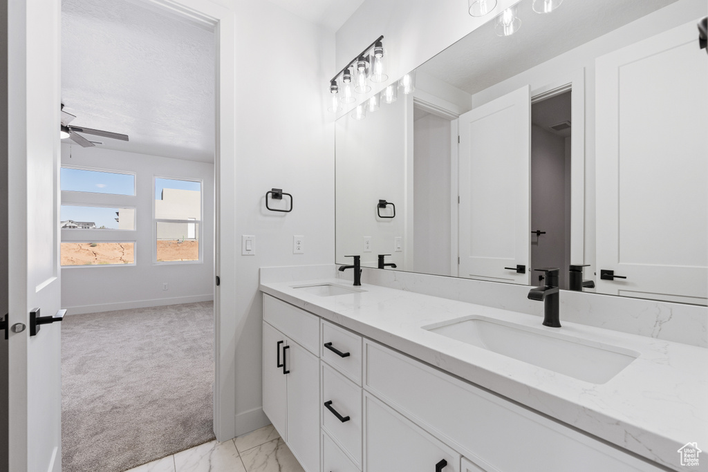 Bathroom featuring ceiling fan and vanity