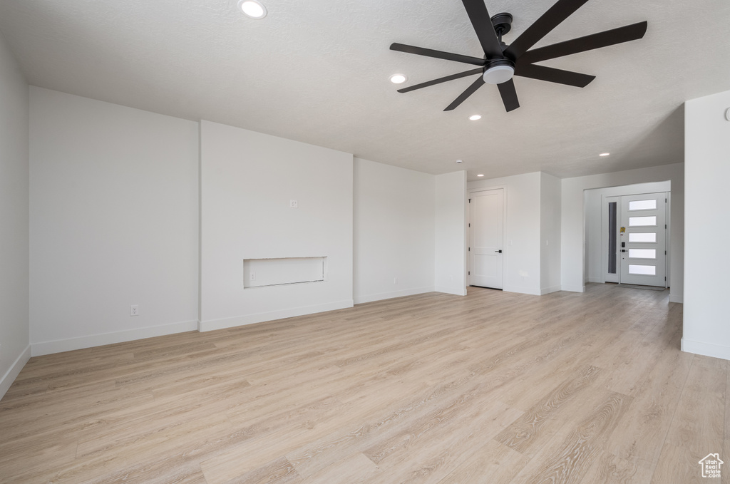 Unfurnished room featuring ceiling fan and light hardwood / wood-style flooring