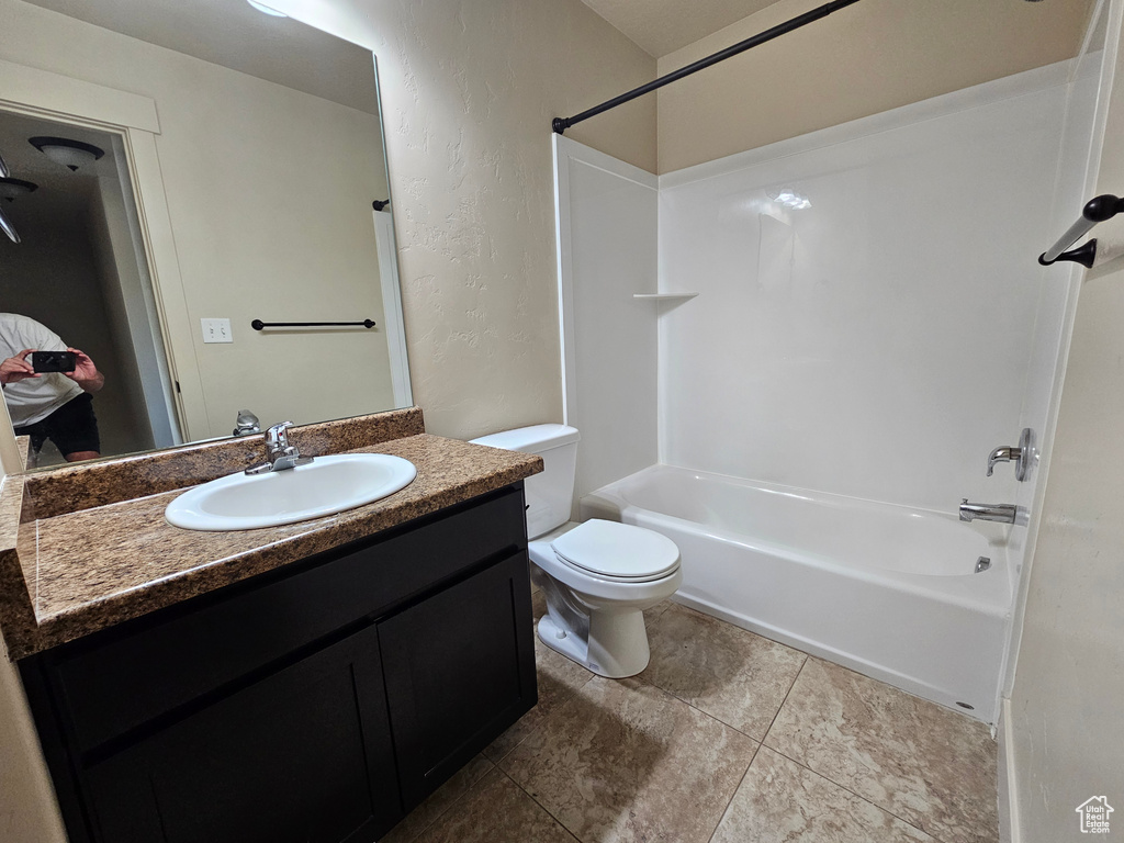 Full bathroom with shower / bathing tub combination, tile patterned floors, vanity, and toilet