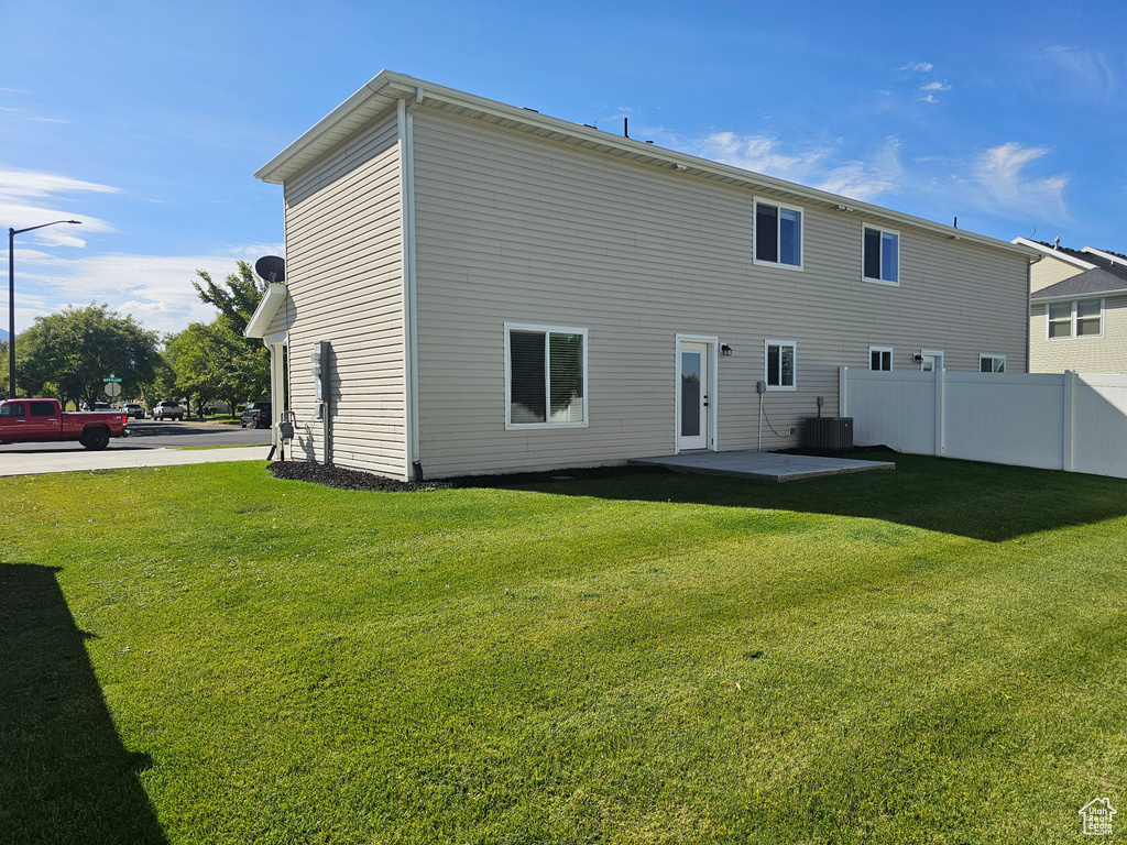 Rear view of house featuring a patio area and a yard