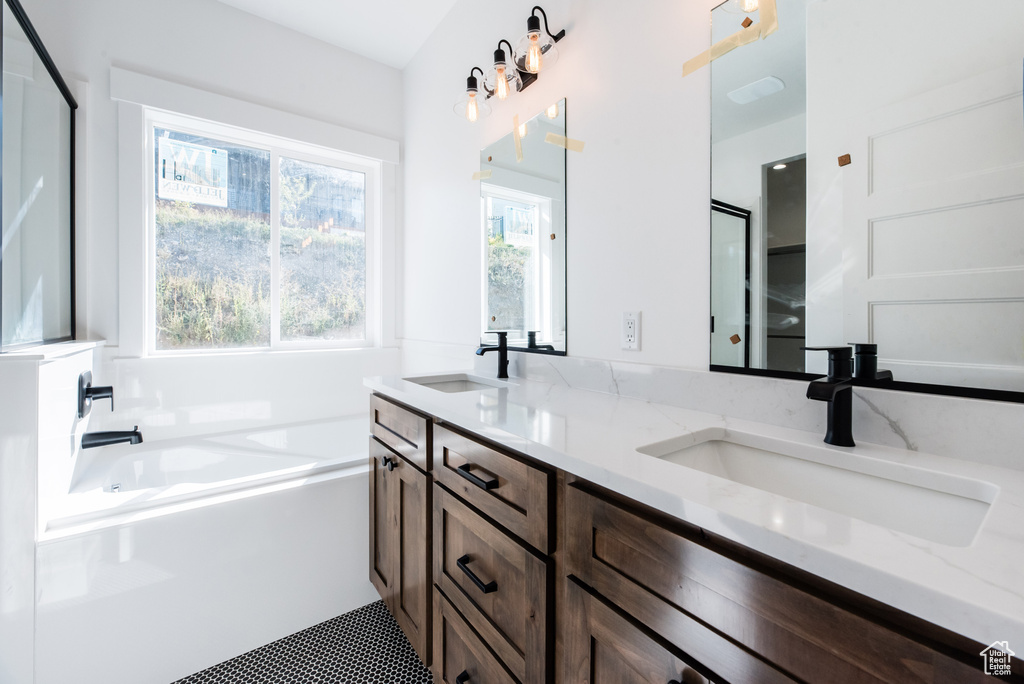 Bathroom with plus walk in shower, tile patterned flooring, and vanity