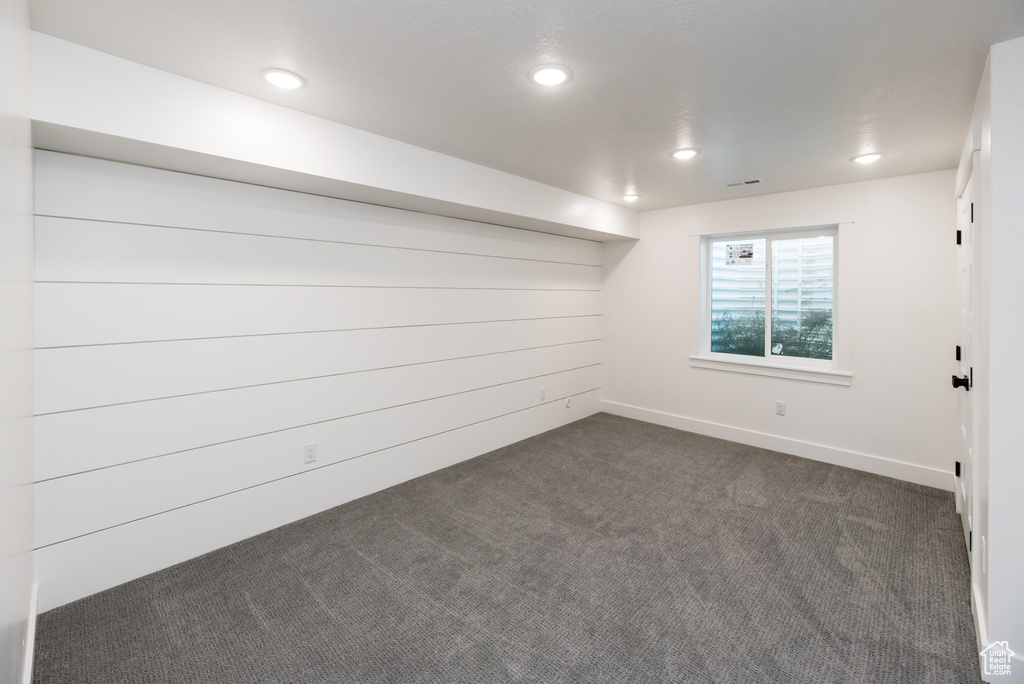 Basement featuring dark colored carpet