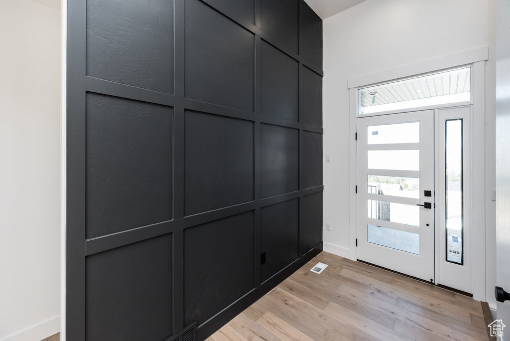 Foyer entrance with light hardwood / wood-style flooring